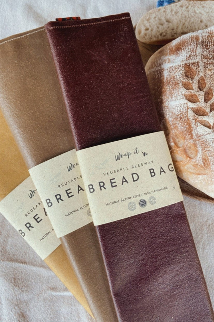 Eco-friendly reusable beeswax bread bag holding a fresh artisan sourdough loaf, made from organic cotton and natural beeswax—perfect for plastic-free, sustainable sourdough bread storage