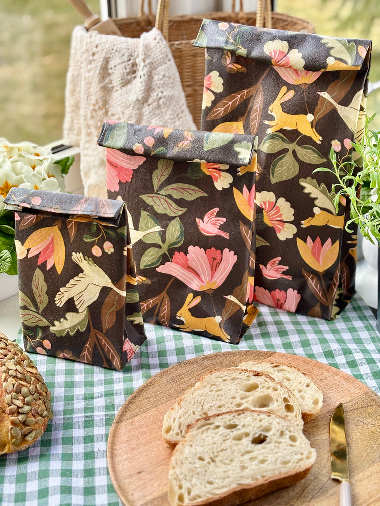 Eco-friendly reusable beeswax bread bag holding a fresh artisan sourdough loaf, made from organic cotton and natural beeswax—perfect for plastic-free, sustainable sourdough bread storage