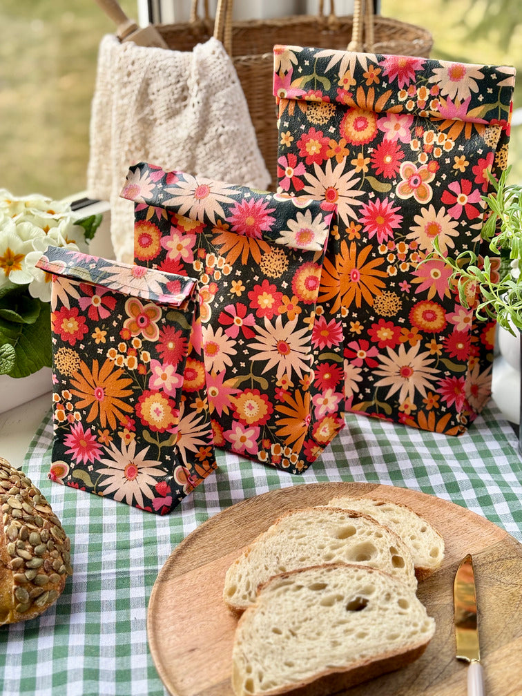 Eco-friendly reusable beeswax bread bag holding a fresh artisan sourdough loaf, made from organic cotton and natural beeswax—perfect for plastic-free, sustainable sourdough bread storage