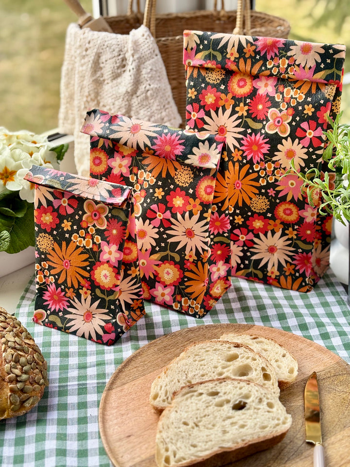 Eco-friendly reusable beeswax bread bag holding a fresh artisan sourdough loaf, made from organic cotton and natural beeswax—perfect for plastic-free, sustainable sourdough bread storage