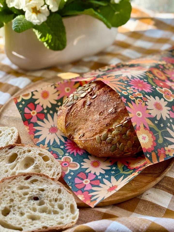 Eco-friendly reusable beeswax bread bag holding a fresh artisan sourdough loaf, made from organic cotton and natural beeswax—perfect for plastic-free, sustainable sourdough bread storage
