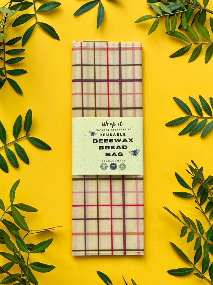 Eco-friendly reusable beeswax bread bag holding a fresh artisan sourdough loaf, made from organic cotton and natural beeswax—perfect for plastic-free, sustainable sourdough bread storage