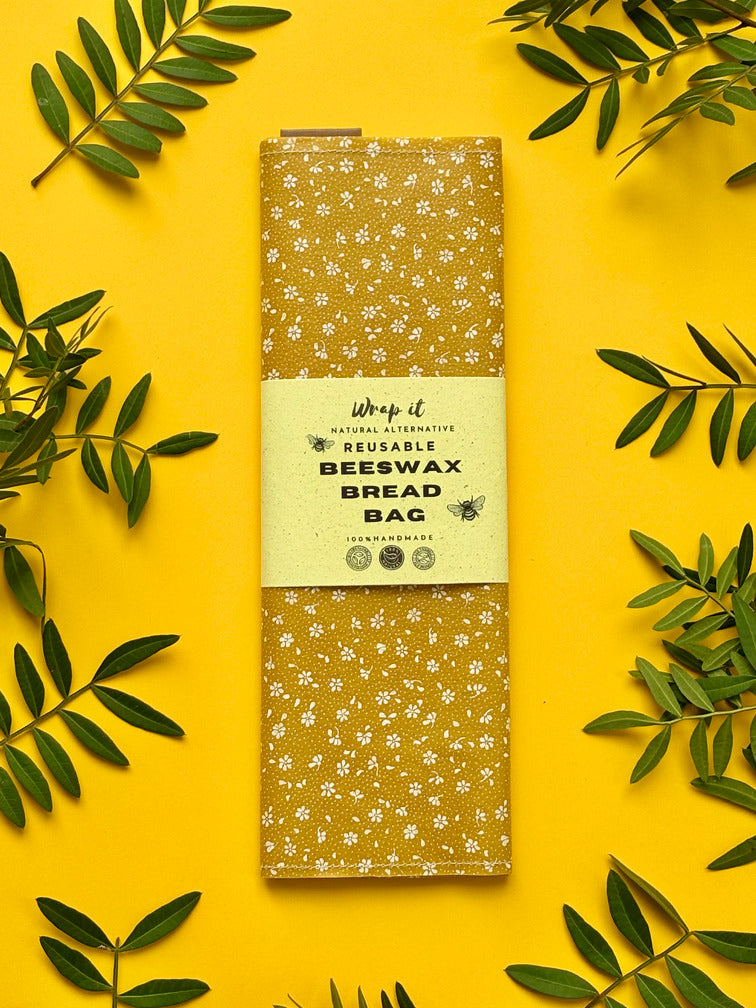 Eco-friendly reusable beeswax bread bag holding a fresh artisan sourdough loaf, made from organic cotton and natural beeswax—perfect for plastic-free, sustainable sourdough bread storage