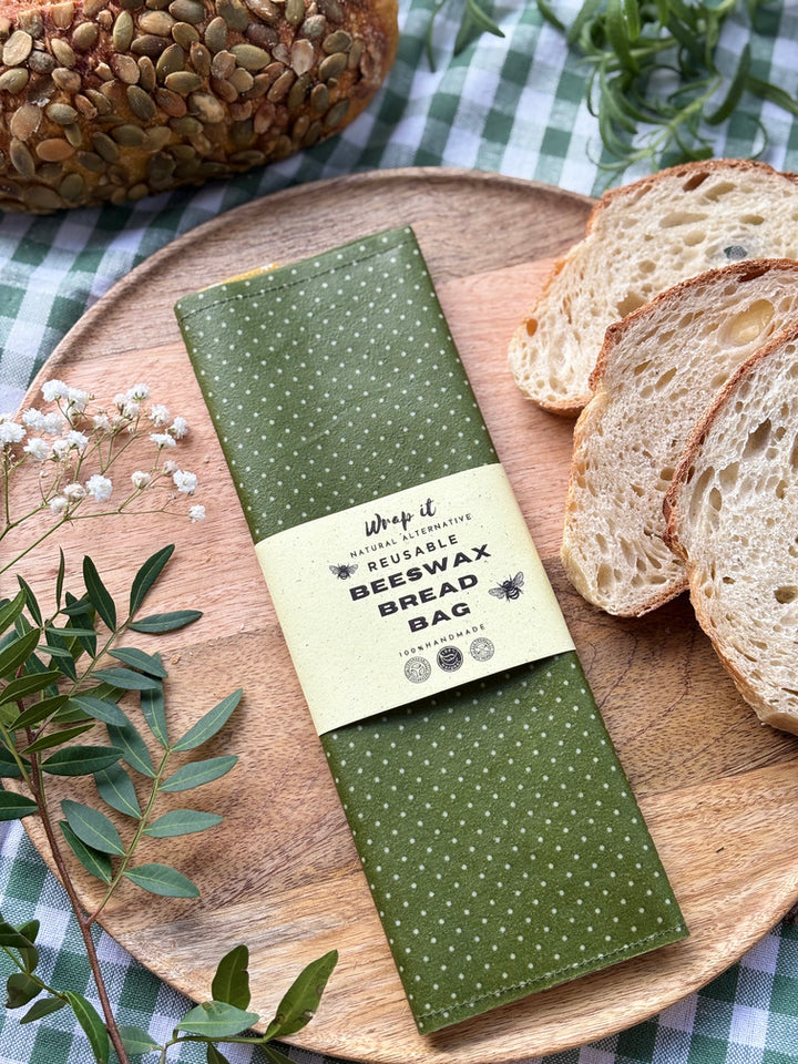 Eco-friendly reusable beeswax bread bag holding a fresh artisan sourdough loaf, made from organic cotton and natural beeswax—perfect for plastic-free, sustainable sourdough bread storage