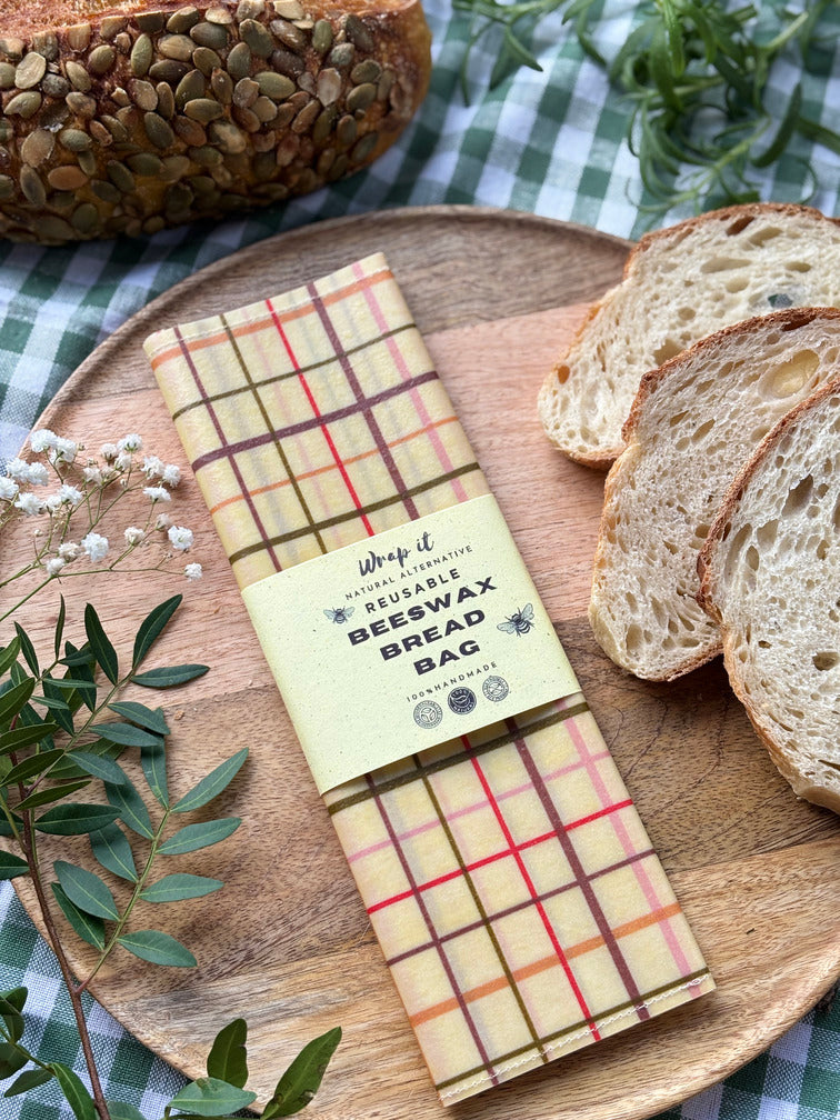 Eco-friendly reusable beeswax bread bag holding a fresh artisan sourdough loaf, made from organic cotton and natural beeswax—perfect for plastic-free, sustainable sourdough bread storage