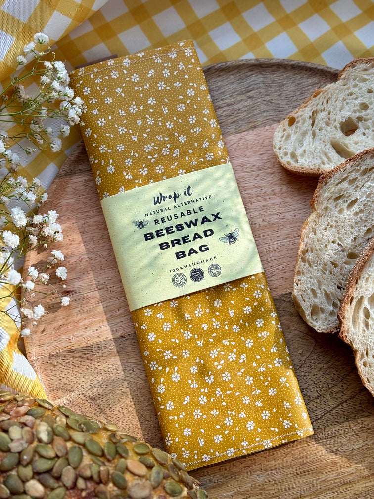 Eco-friendly reusable beeswax bread bag holding a fresh artisan sourdough loaf, made from organic cotton and natural beeswax—perfect for plastic-free, sustainable sourdough bread storage