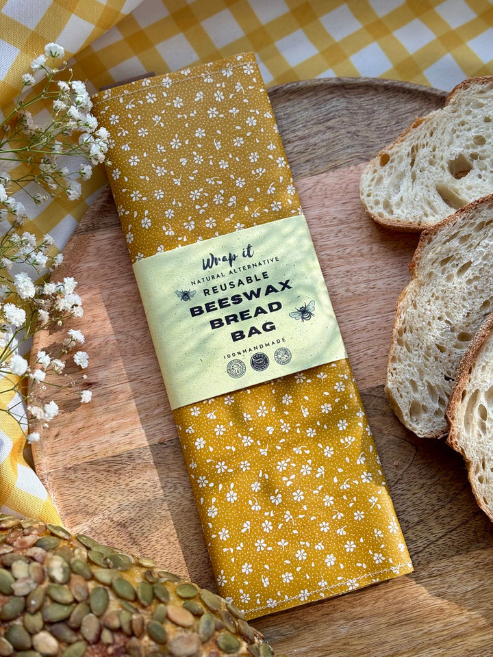 Eco-friendly reusable beeswax bread bag holding a fresh artisan sourdough loaf, made from organic cotton and natural beeswax—perfect for plastic-free, sustainable sourdough bread storage