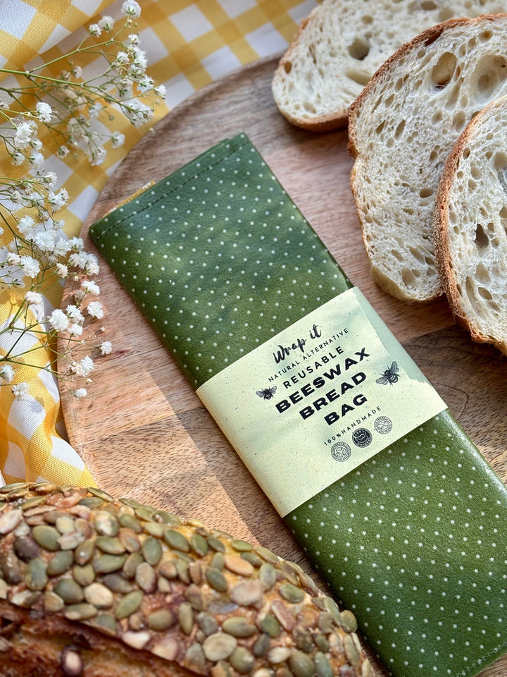 Eco-friendly reusable beeswax bread bag holding a fresh artisan sourdough loaf, made from organic cotton and natural beeswax—perfect for plastic-free, sustainable sourdough bread storage