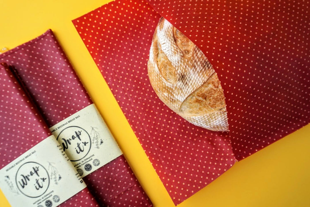 Eco-friendly reusable beeswax bread bag holding a fresh artisan sourdough loaf, made from organic cotton and natural beeswax—perfect for plastic-free, sustainable sourdough bread storage