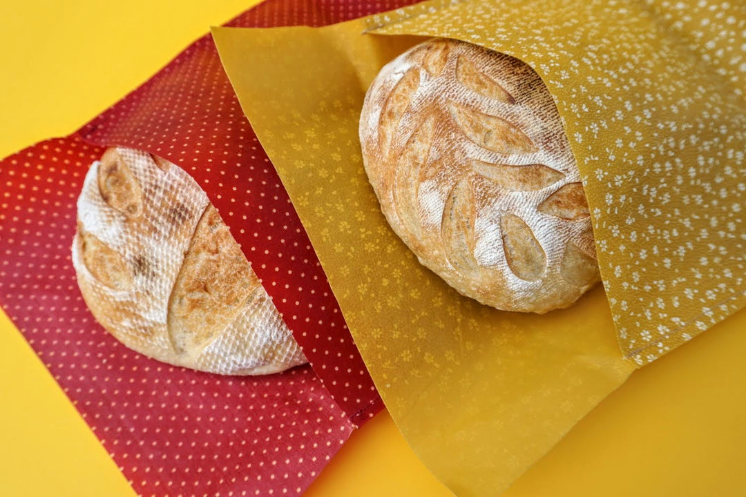 Eco-friendly reusable beeswax bread bag holding a fresh artisan sourdough loaf, made from organic cotton and natural beeswax—perfect for plastic-free, sustainable sourdough bread storage